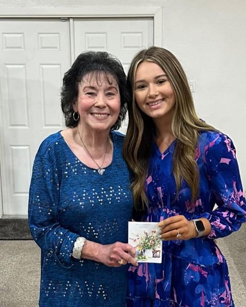 Pastor Joyce Pattison smiling beside a young woman from the church